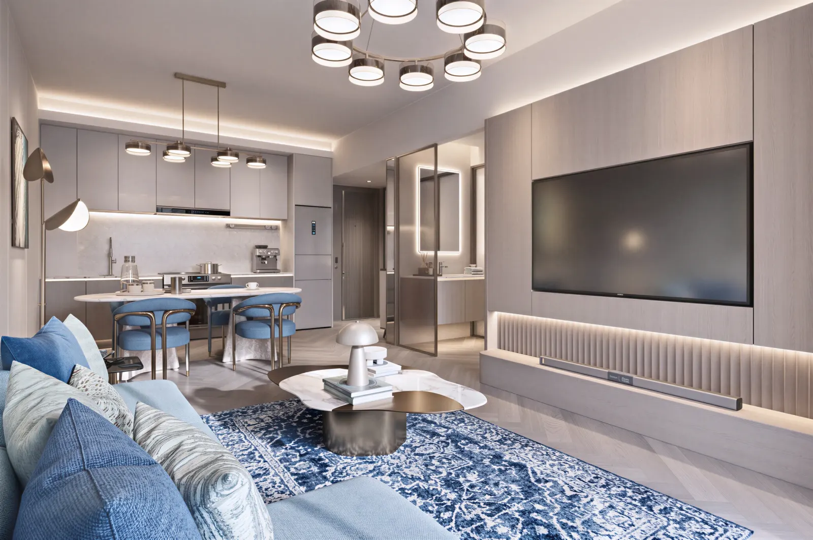 Living room with a pale blue sofa, looking toward the dining table and kitchen.