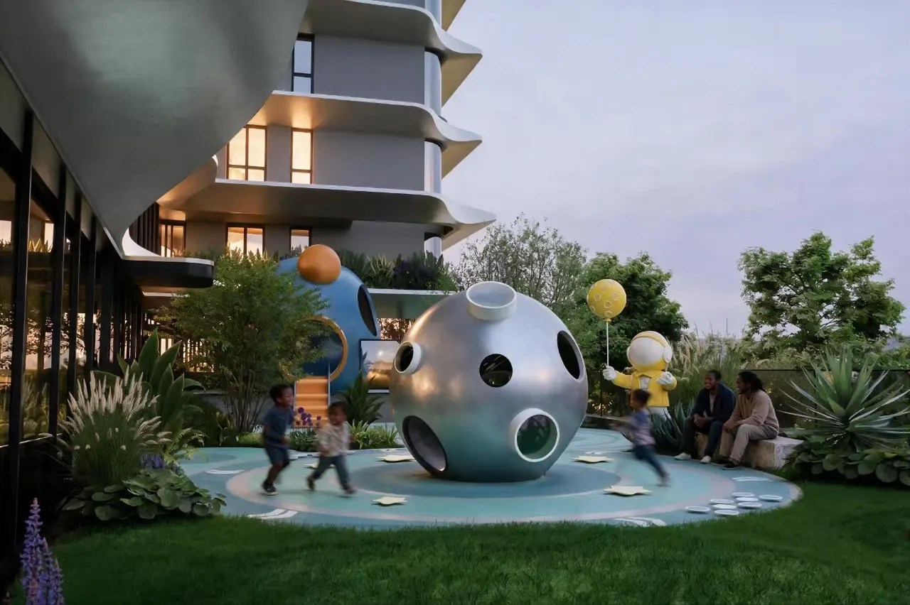 A landscaped children’s play garden with sculptural play spheres beside the tower.
