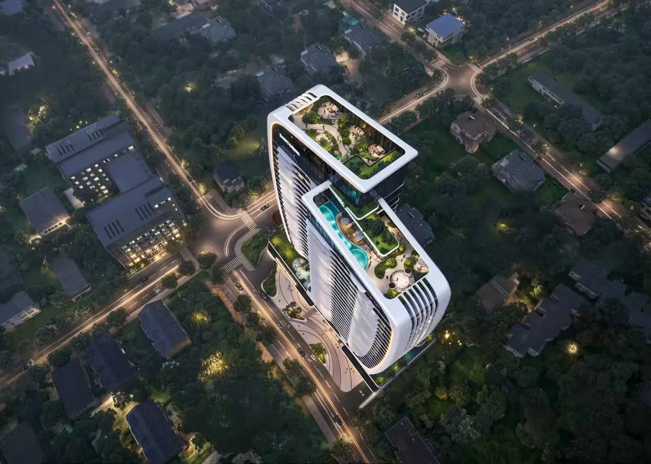 Aerial night view of Santorini Residences, showing the rooftop gardens, pools, and curved tower above the surrounding streets.