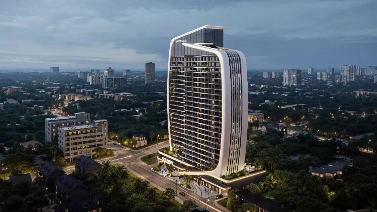 Santorini Residences at dusk, the curved white tower rising above the trees and rooftops of Westlands.